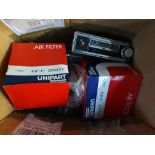 A box of mainly MGB spares, together with a car radio.