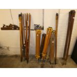 A collection of surveying equipment including tripods and fittings, together with three wood planes.