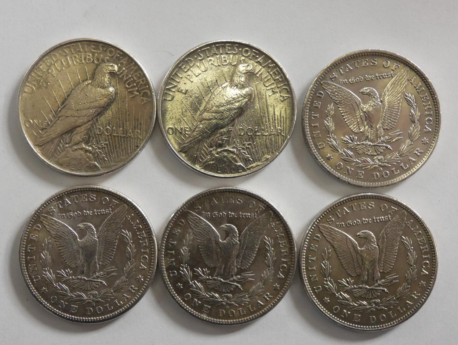 A collection of six silver dollar coins, 1881 San Francisco mint, 1883 and 1884 New Orleans mint,