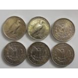 A collection of six silver dollar coins, 1881 San Francisco mint, 1883 and 1884 New Orleans mint,