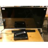 A Samsung 32 inch LCD television, together with a Matsui digital top box (2).