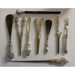 An Edwardian silver handled crimper, Chester 1902, two pairs of silver handled glove stretches,