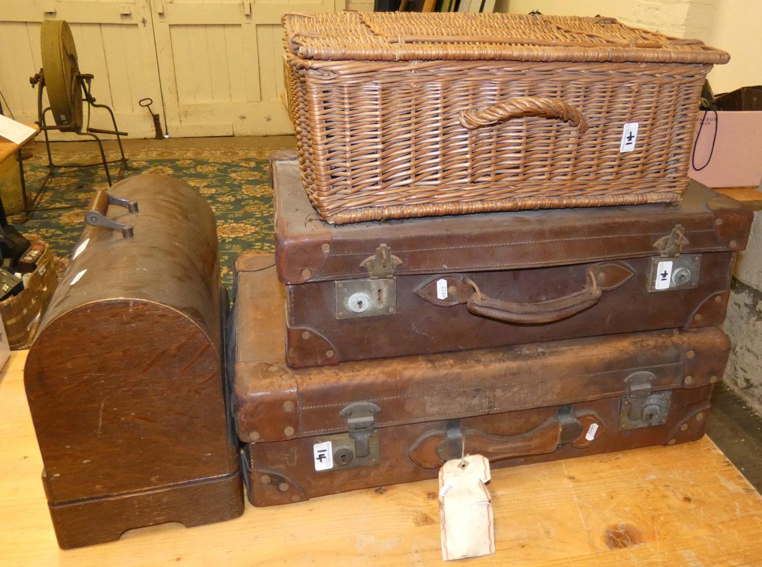 A Singer sewing machine together with two leather suitcases and a wicker basket (4).