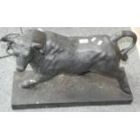 A painted cast metal model of a bull, 59cm long.