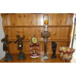 A pair of spelter figurines 'Musique & Melodie' on wooden plinths, together with a mantel clock,