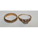 A 9ct gold single stone diamond ring and a 9ct gold wedding band, 5.5 grams.