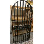 A pair of cast iron arched gates 192cm tall x 87cm wide, together with a smaller matching gate 105cm