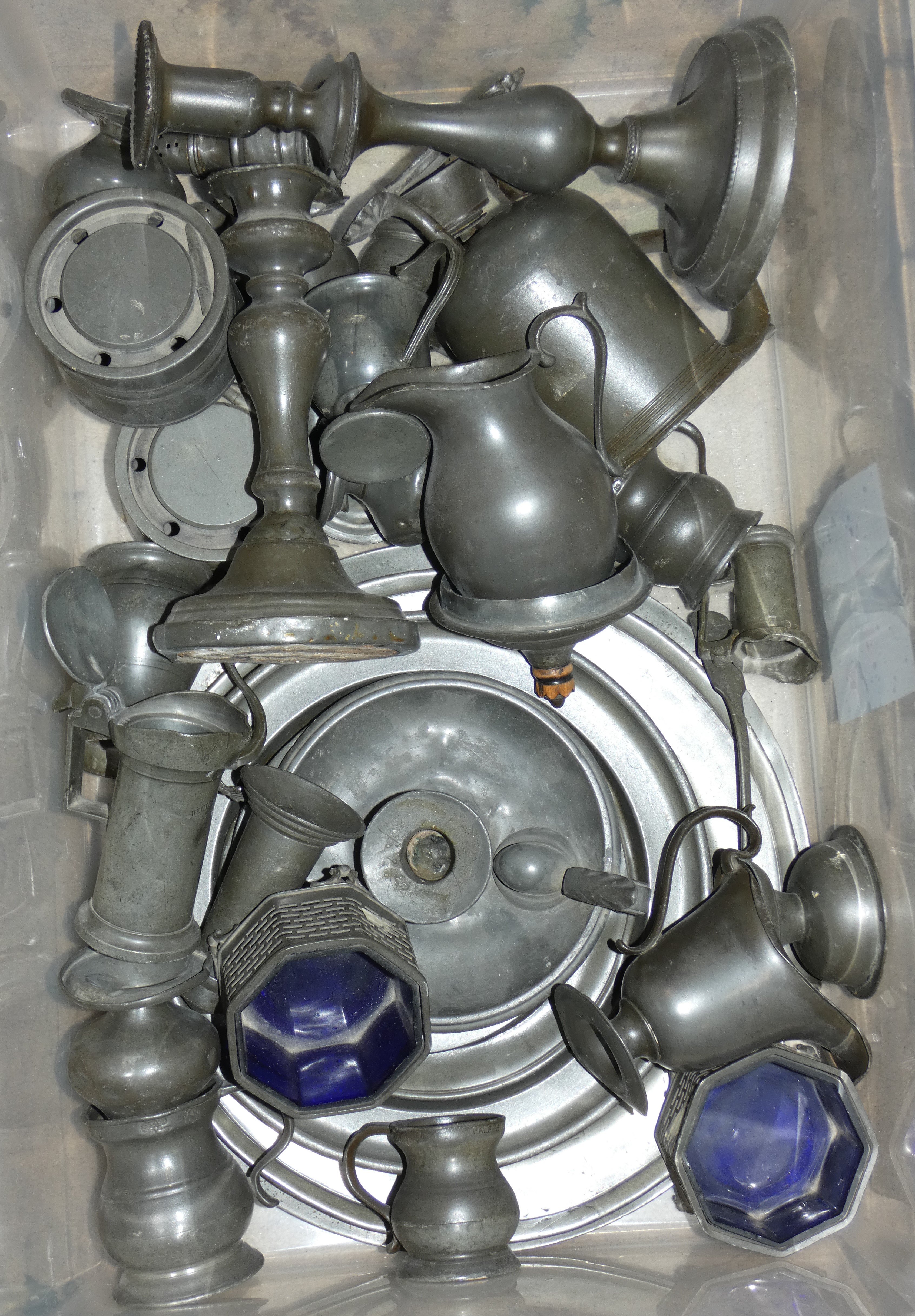 A quantity of pewter metalware including tankards, candlesticks and plates