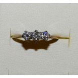 An 18ct gold three stone diamond ring, claw set with brilliant cut stones, total weight
