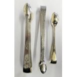 A pair of George III silver bright cut sugar tongs, London 1806, another pair, no date letter and an