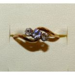 An 18ct gold three stone diamond ring, claw set with graduated old cut brilliant stones, total