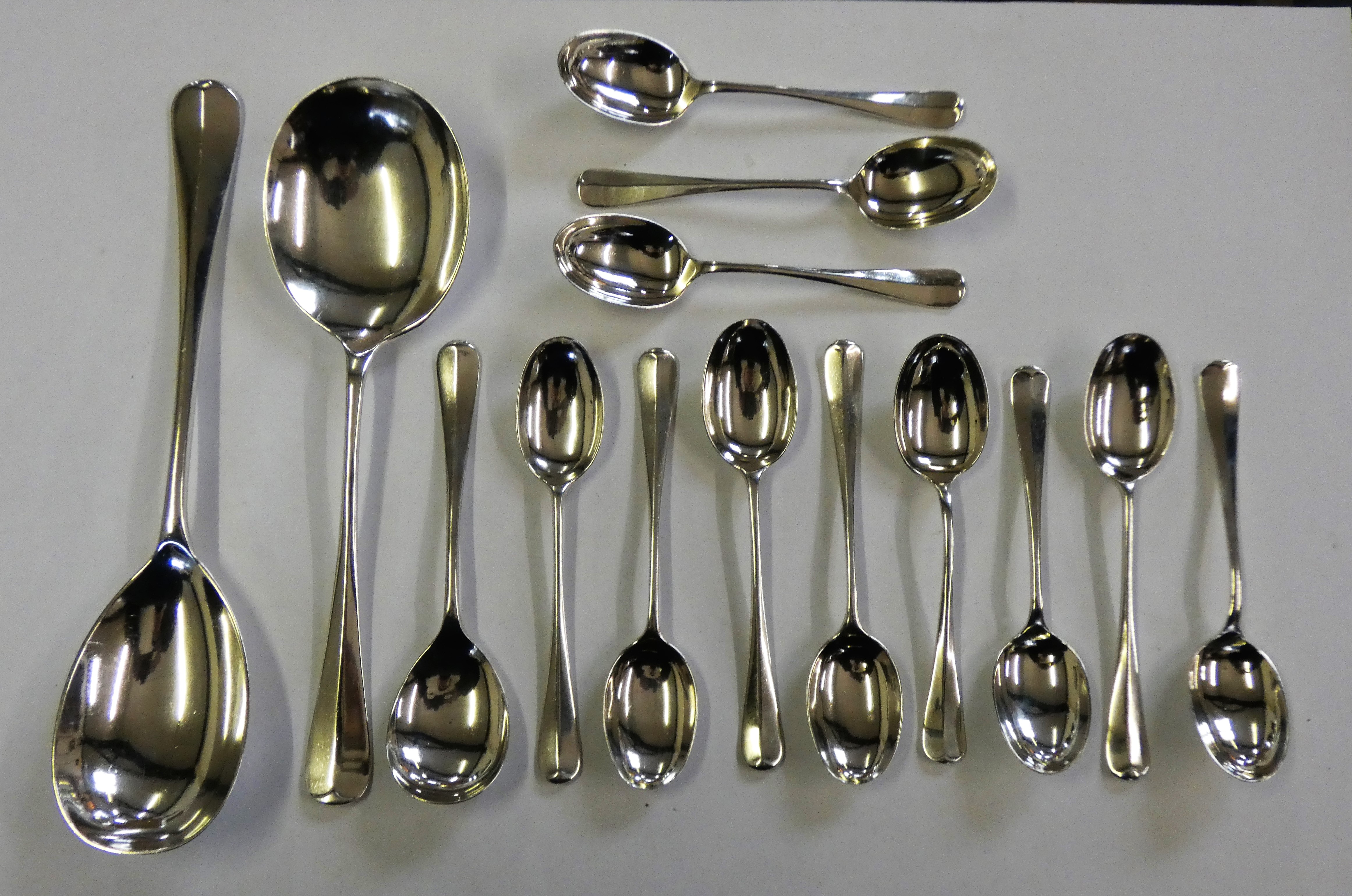 A silver set of six Hanoverian rat tail pattern coffee spoons, Sheffield 1932, five matching tea