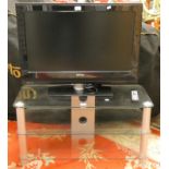 A Phillips LCD TV 32", together with a glass three tier TV stand