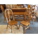 Substantial solid oak dining table with two leaves together with a matching set of eight solid