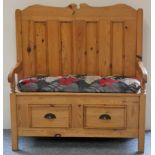 Modern waxed pine hall settle or bench, carved back decorated with panels, curved arms on each side,