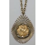 A 9ct gold mounted sovereign pendant, the 1915 coin loose set, chain, gross weight 22.5 gms.
