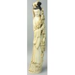 A Japanese ivory Okimono, in the form of a lady carrying a rose and a basket of fruit, black hair,