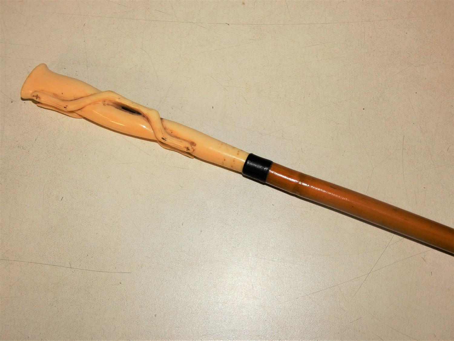 An early 20th century ivory topped bamboo cane, the handle carved and initialled M.P.R., length 88