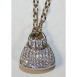 An 18 ct white gold and diamond set handbag pendant, pave set with brilliant cut stones, total