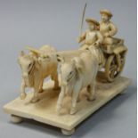 A late 19/early 20th century Indian carved ivory group, depicting a cart being pulled by two