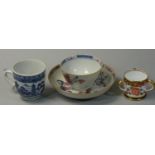 A New Hall tea bowl and saucer, painted with floral decoration. a blue and white coffee cup and a