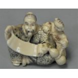 A Japanese Ivory Netsuki, carved in the form of a seated man with a scroll, signed, 3.5 cm.