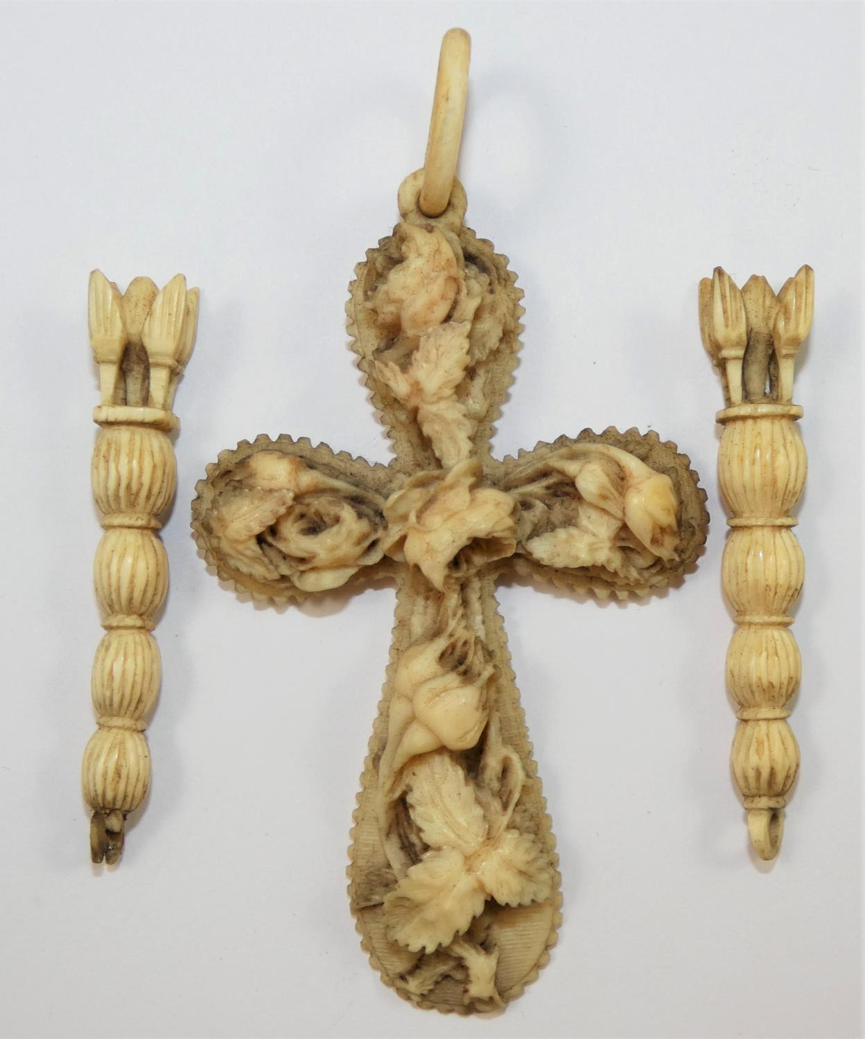 A Victorian carved ivory cross, decorated with roses, length 9 cm, together with a pair of carved