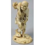 A Japanese Meiji period Ivory Okimono, carved to depict a old fisherman with fish and crab,