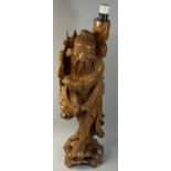 A Chinese rootwood carved figure, depicting a man carrying vegetables, 63 cm.