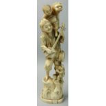 A Japanese Ivory Okimono, in the form of a musician with a child on his shoulder and a monkey by his
