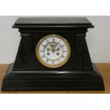 An Egyptian Revival black slate clock garniture, the white enamel two part dial with visible