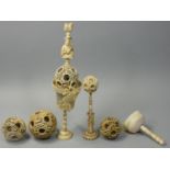 A 19th century Cantonese ivory puzzle ball on stand, the outer ball carved with flowers, five