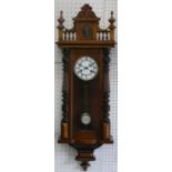 A Vienna style walnut wall clock, with two part white enamel dial with Roman numerals, to an