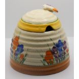 A Clarice Cliff Bizarre beehive preserve pot, Marquerite pattern, 9.5cm.