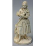 A Victorian carved ivory statue, depicting a knight in battle dress holding his sword, helmet by his