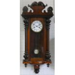 A Vienna style walnut wall clock, with two part white enamel dial with Roman numerals, to an