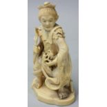 A Japanese Meiji period Ivory Okimono, carved to depict a man holding two toads, signed, height 10.5