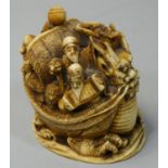 A Japanese Ivory group, carved as a dragon ship with human crew, signed, 6.5 cm.