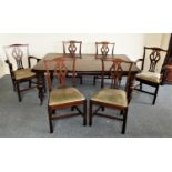 A Victorian mahogany extending dining table and chairs, with thumb nail edge, raised on turned