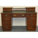 An Edwardian mahogany pedestal desk, the invert T green leather insert with turned central gallery