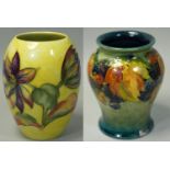 A Moorcroft pottery flambé vase, tubeline decorated in the Leaf and Berry pattern, with impressed