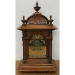 A German Black Forest mahogany chiming bracket clock, by Badische Uhrenfabrik, with arched brass