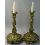 A pair of gilt metal ornate cast candlesticks, decorated with insects, butterfly's and bees, 32 cm.