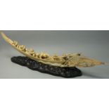 A Japanese Meiji period Ivory Okimono, carved to depict a fishing boat with six sailors hauling a