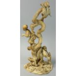 A Japanese Meiji Period Sectional Ivory Okimono, in the form of a serpent fighting two men,