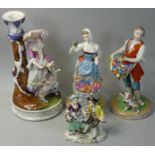 Four continental style German made figure groups, to include woman with flowers and dog marked '