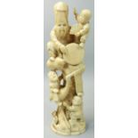 A Japanese ivory Okimono, in the form of a man seating on a tree with three children, one riding a