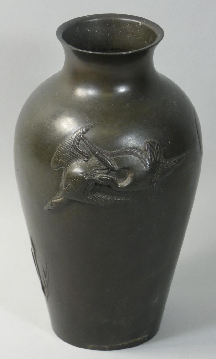 A Japanese bronze baluster vase, of baluster form with bird decoration, height 23 cm.