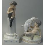 A Royal Copenhagen model printed and painted as the seated figure of a young faun playing with a kid