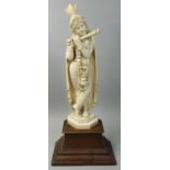 An early 20th century Indian ivory figurine, An early 20th century Indian ivory figurine, carved